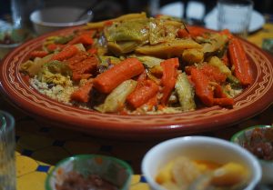 Traditional Moroccan couscous served at Nomad Surf Camp. Authentic Moroccan cuisine experience